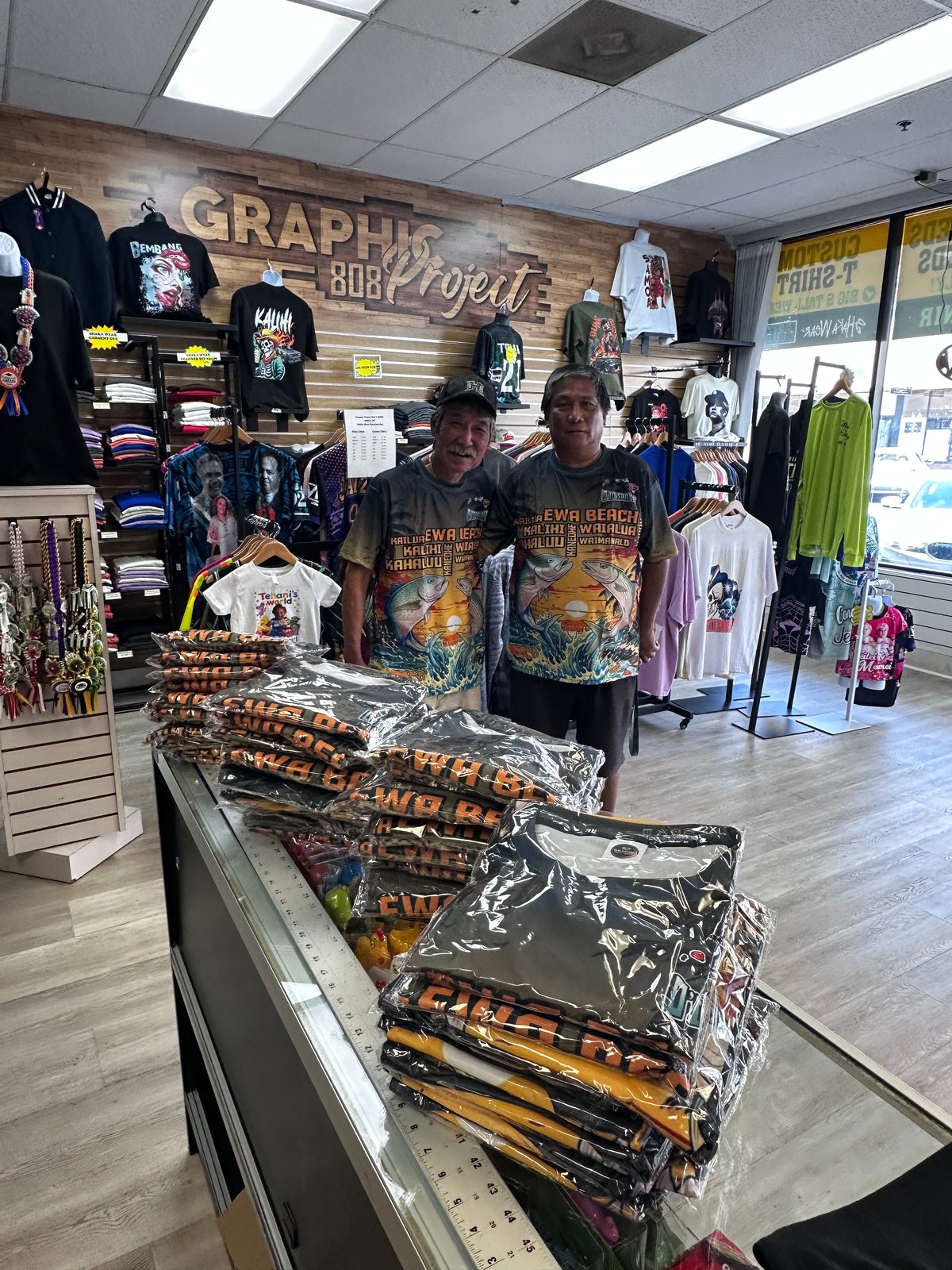 The team at Graphic Project 808 with custom-printed shirts in Kalihi