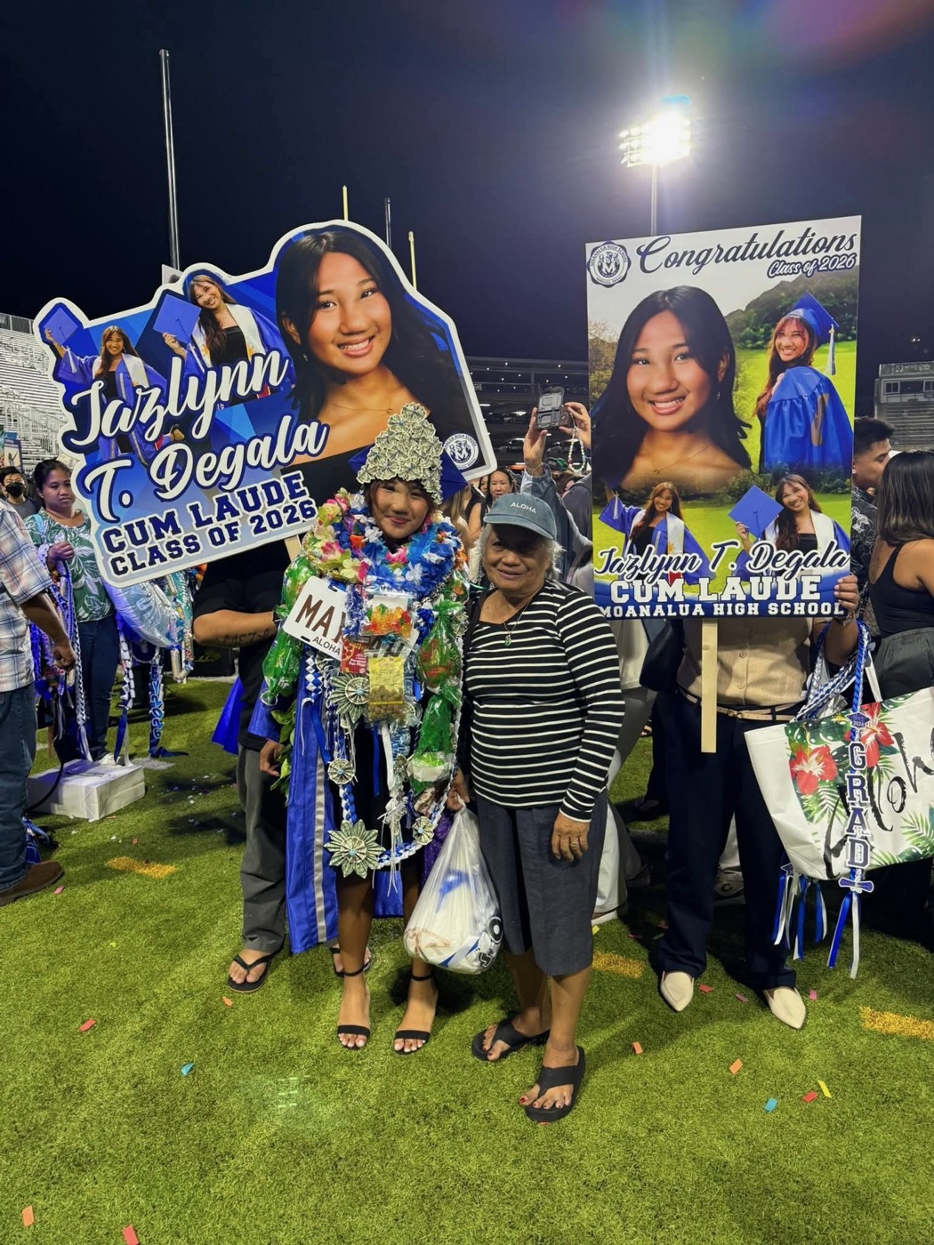 Customer holding large custom-printed graduation posters made at Graphic Project 808