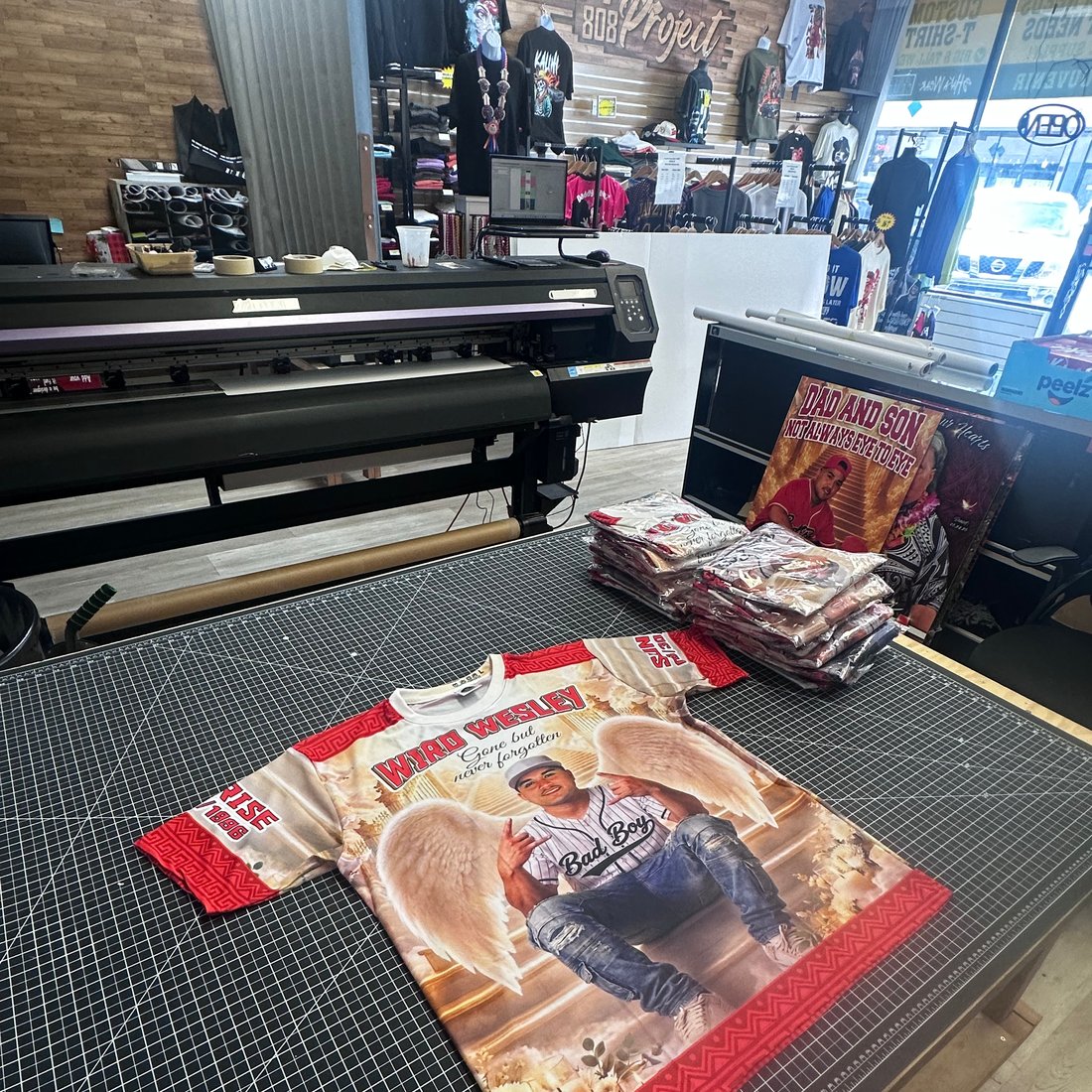 Large-format printer with a finished custom photo jersey at Graphic Project 808